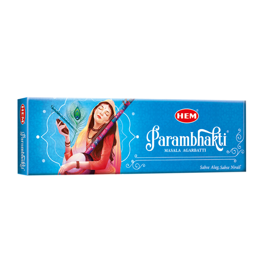 A blue box of HEM Param Bhakti Masala Agarbattti incense sticks with an illustration of a person in traditional attire playing a musical instrument and a peacock feather design.
